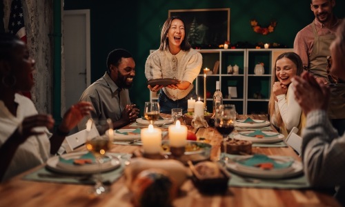Friends gathering around a dinner table for a feast